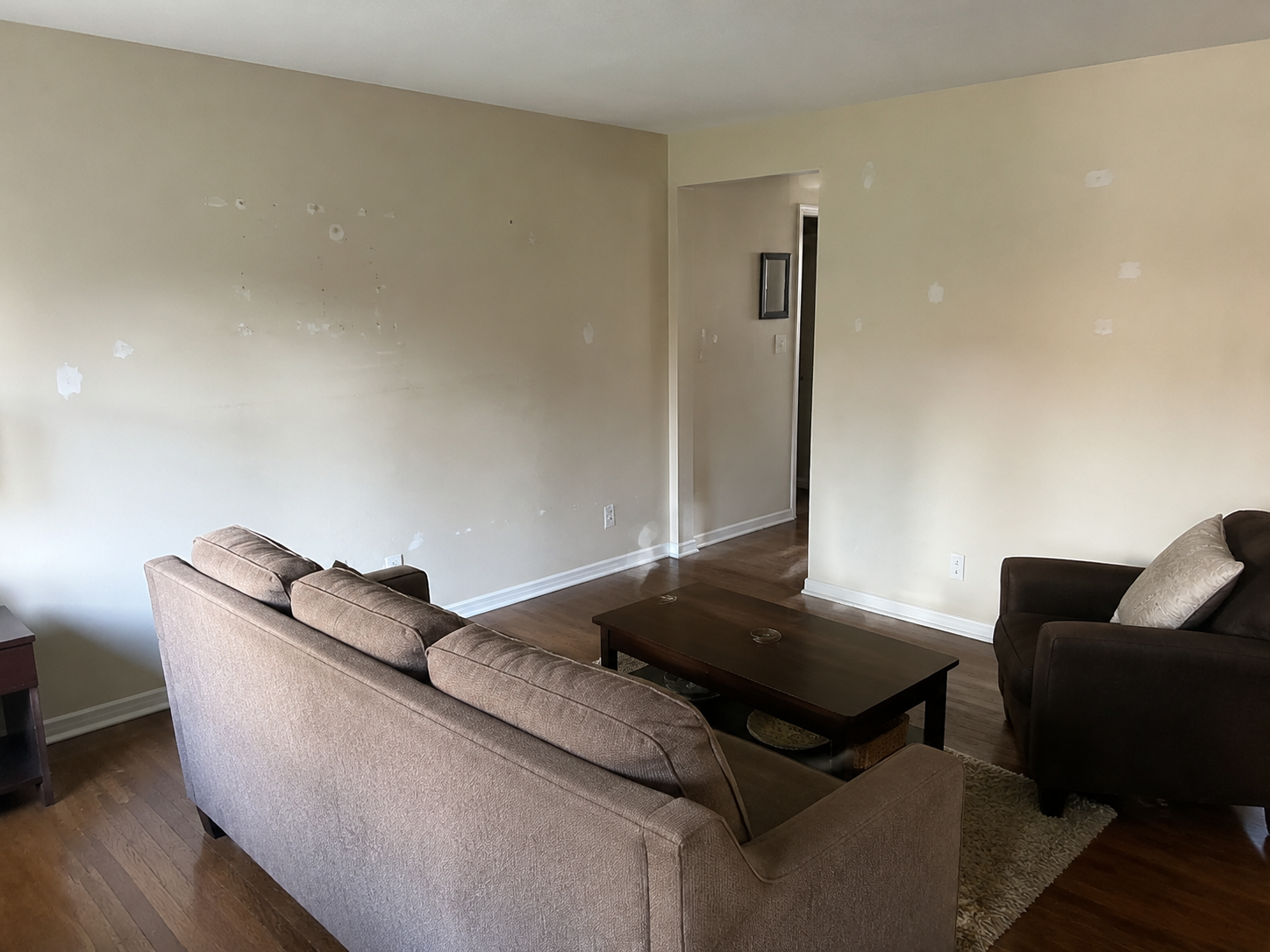 Living room walls with scuffs and patching before repainting